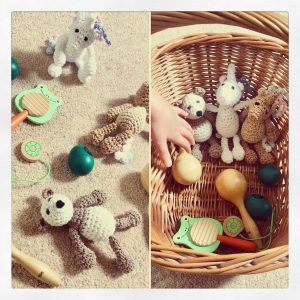 Basic cleaning activities: collecting toys in a basket.