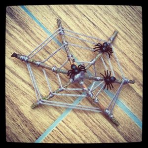 Twig spider web with 3 spiders.