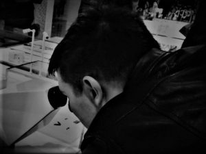 Interview with Chris Scott; photo of Chris with a microscope.