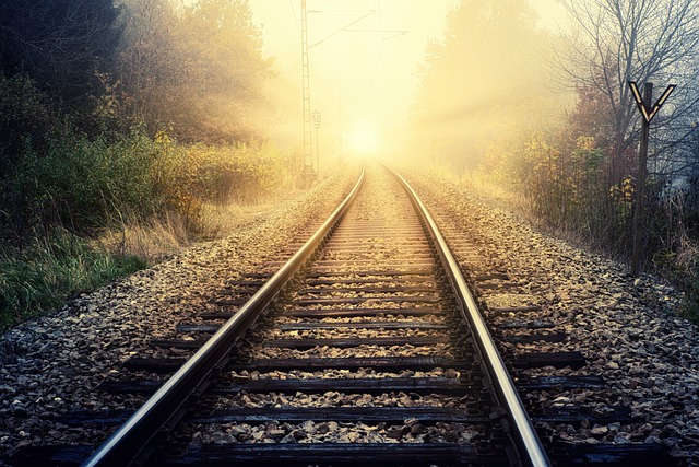 Sunlight at the end of railway tracks, symbolising finding the light at the end of a tunnel after a long, hot minute.